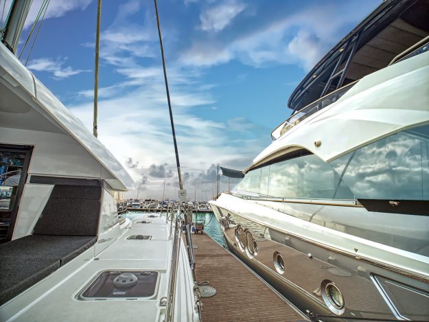 A luxury yatchs are berthing at the jetty of yatch on sunset.